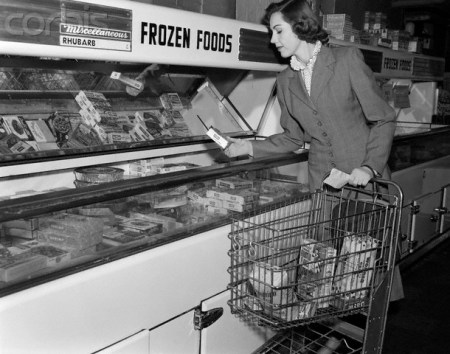 1950s Woman Shopping Frozen Food Section Of Grocery Store