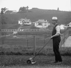 man-pushing-mower-ca-1920
