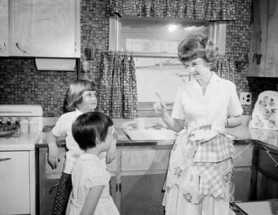 Mother reprimanding children in kitchen