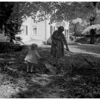 grandmother-with-granddaughter-raking-leaves-in-garden-poster-print-18-x-24_852695