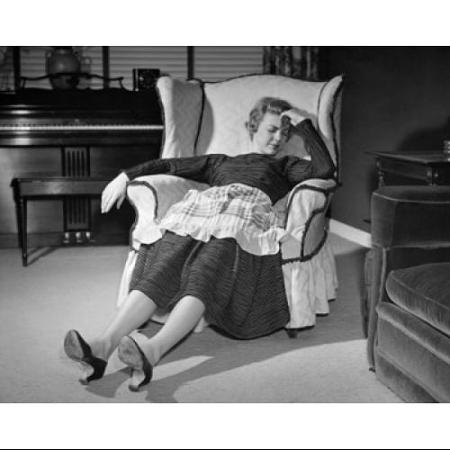 mid-adult-woman-sleeping-on-an-armchair-poster-print-18-x-24_5143633